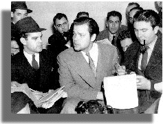 Orson Welles (center) meets the press